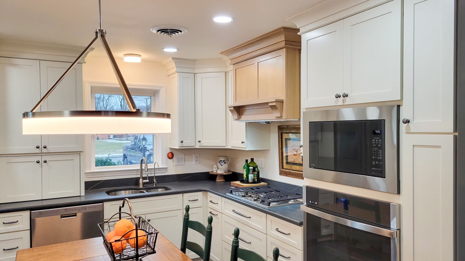 Kitchen with white cabinets, stainless steel appliances, and dark countertops.