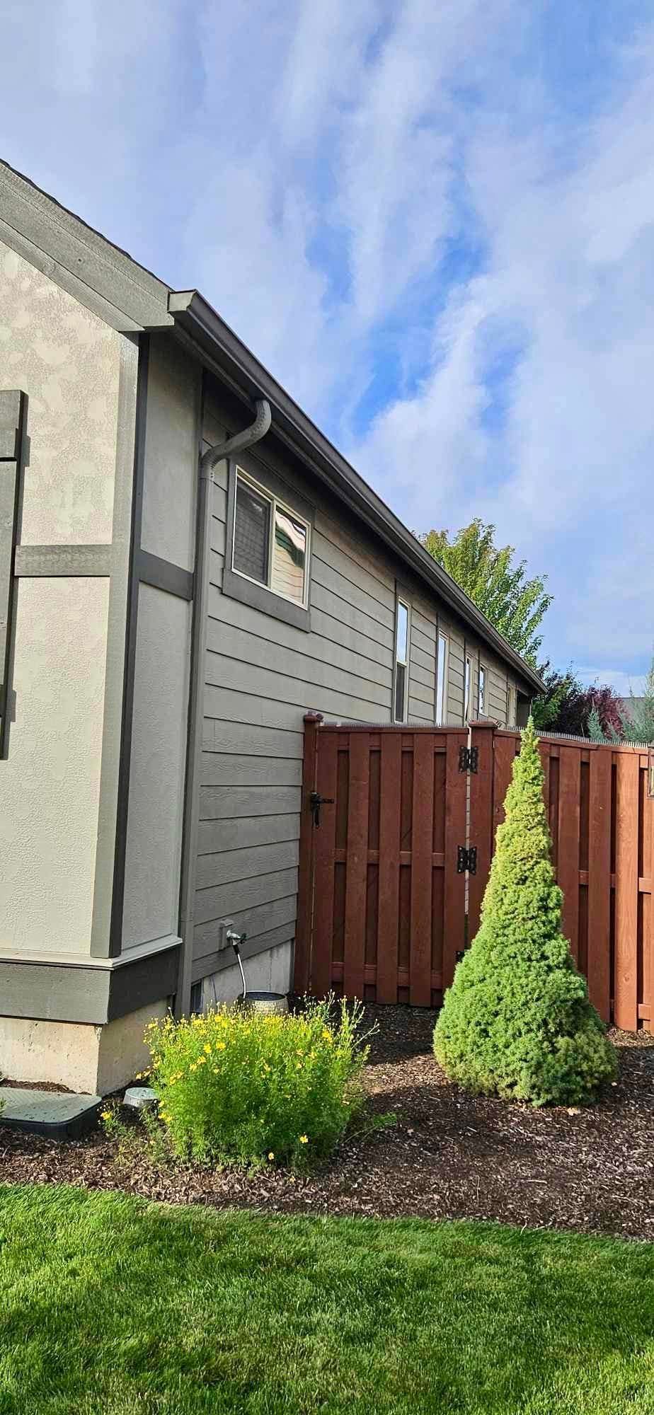 A house with a wooden fence in front of it.