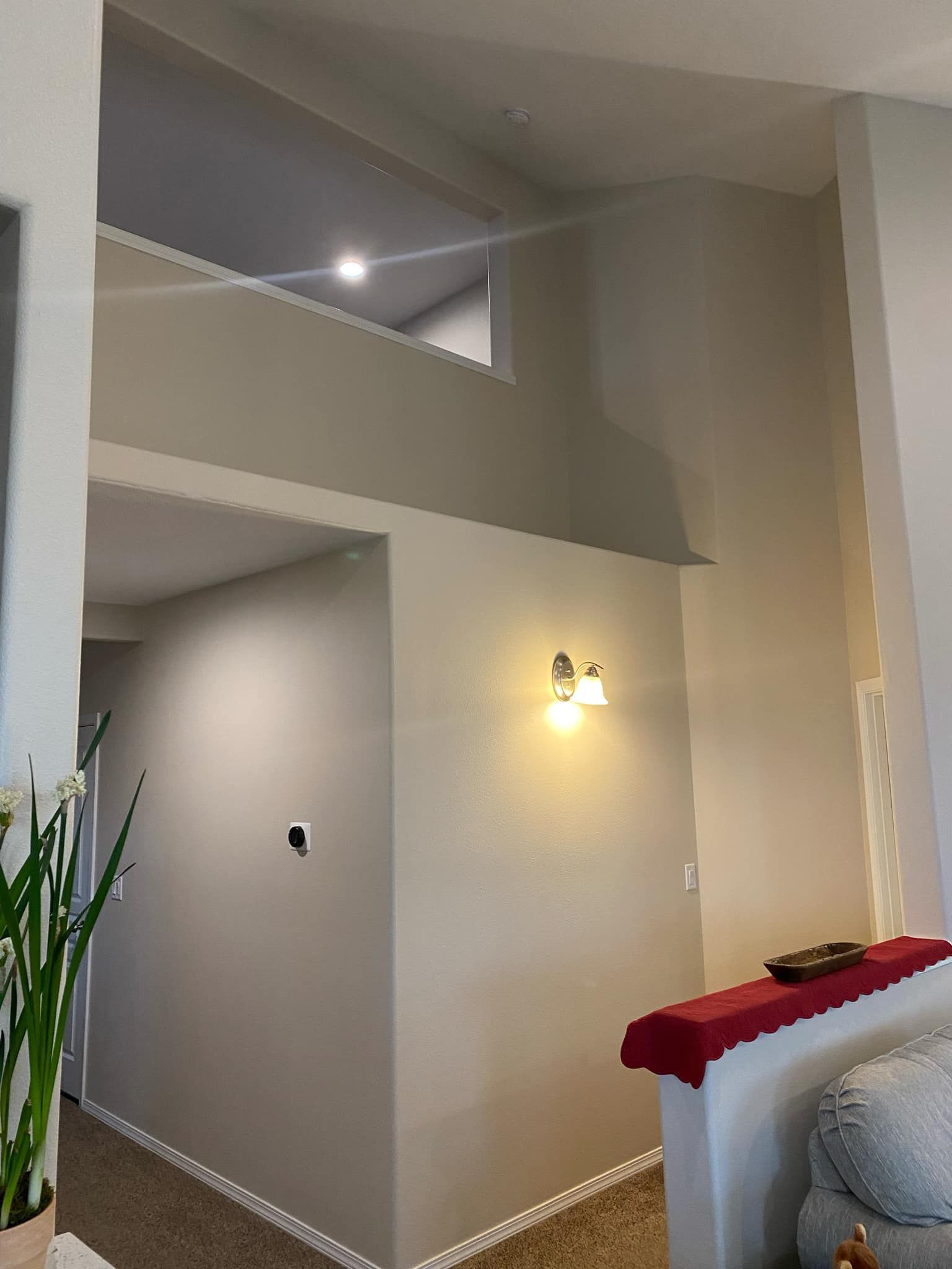 A living room with a couch , chair , and a window.