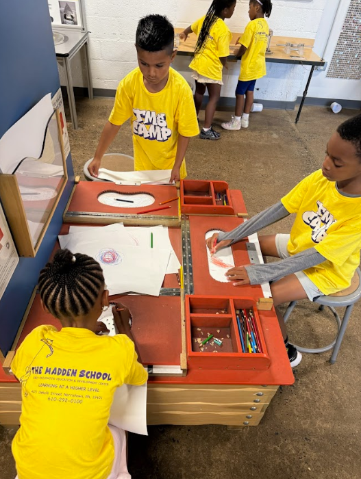 A group of children wearing yellow shirts that say take a dump