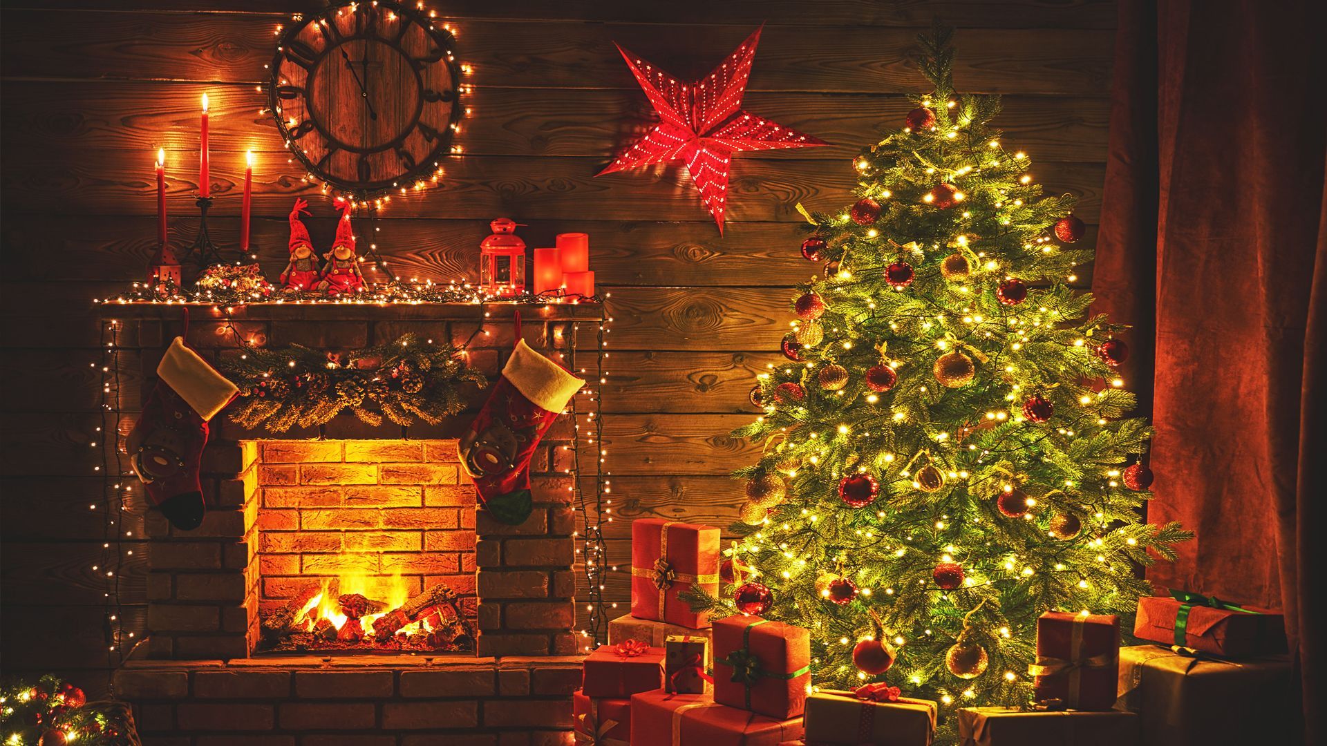 A living room decorated for christmas with a fireplace and a christmas tree.