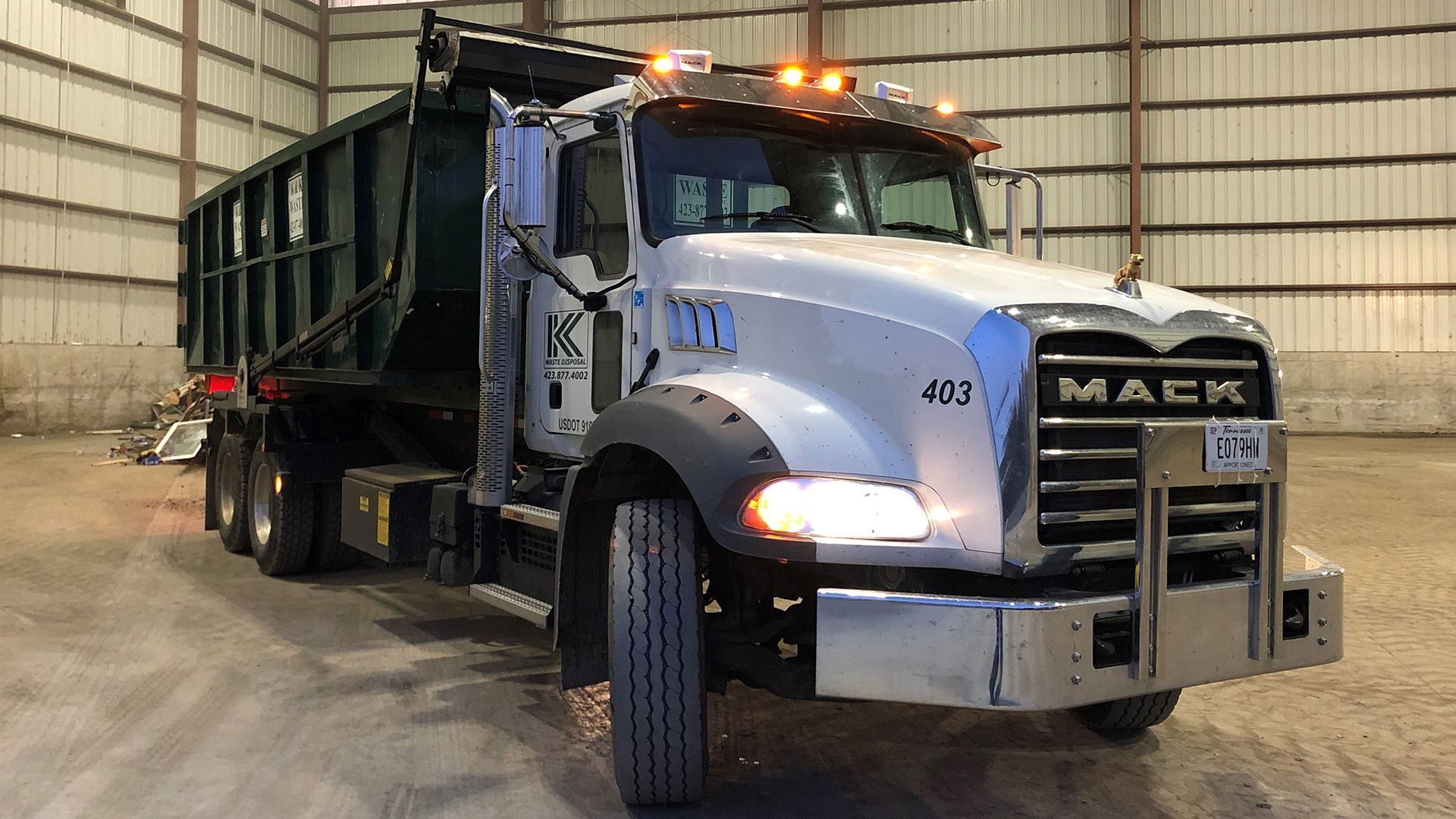 A dump truck is parked in a warehouse.