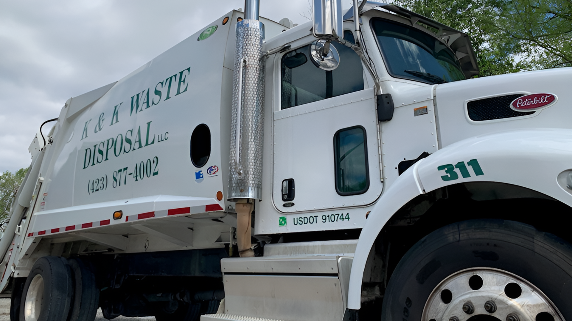 A white residential garbage service truck.