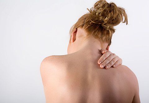 a woman with neck pain