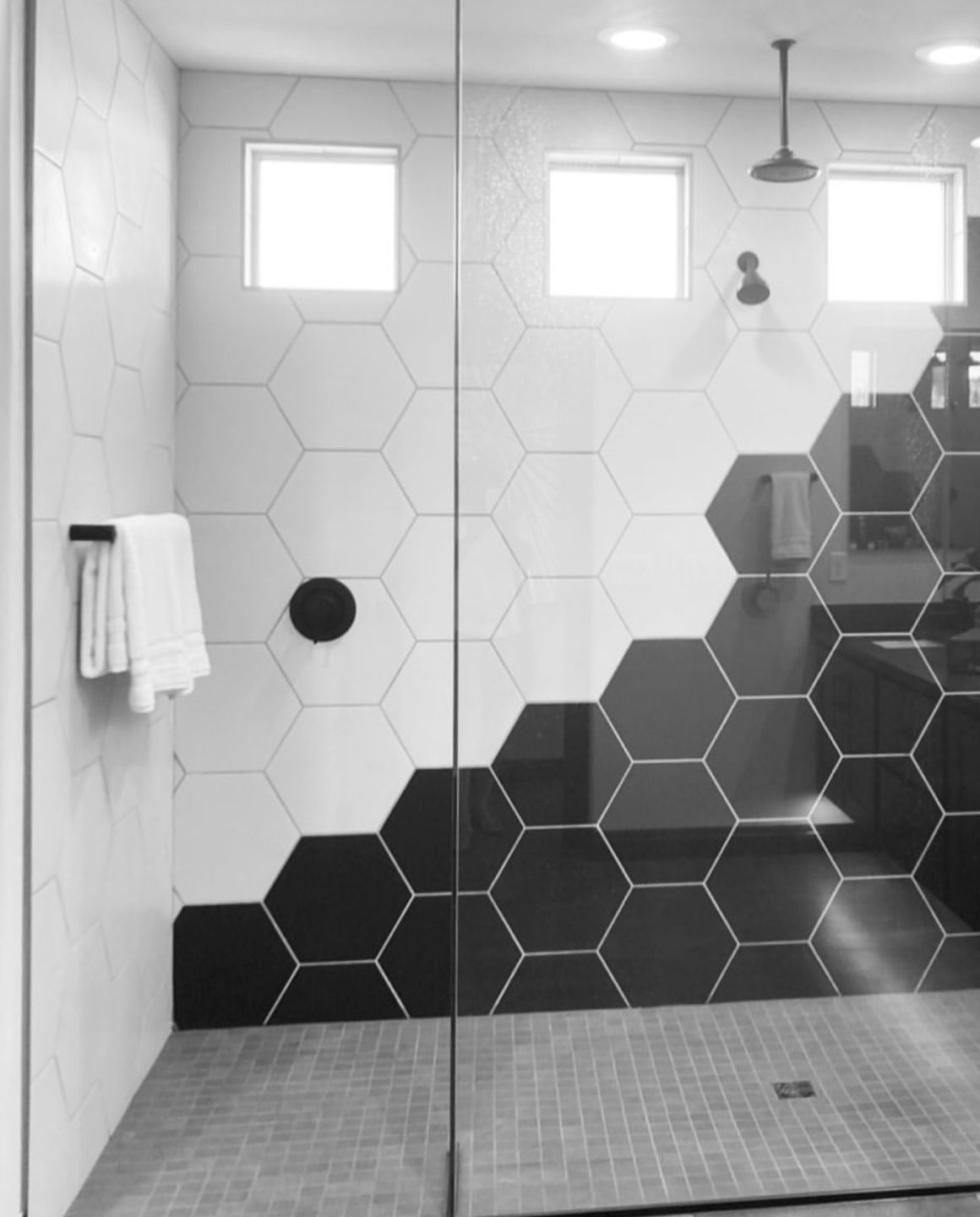 Restroom with glass door and patterned tiles design