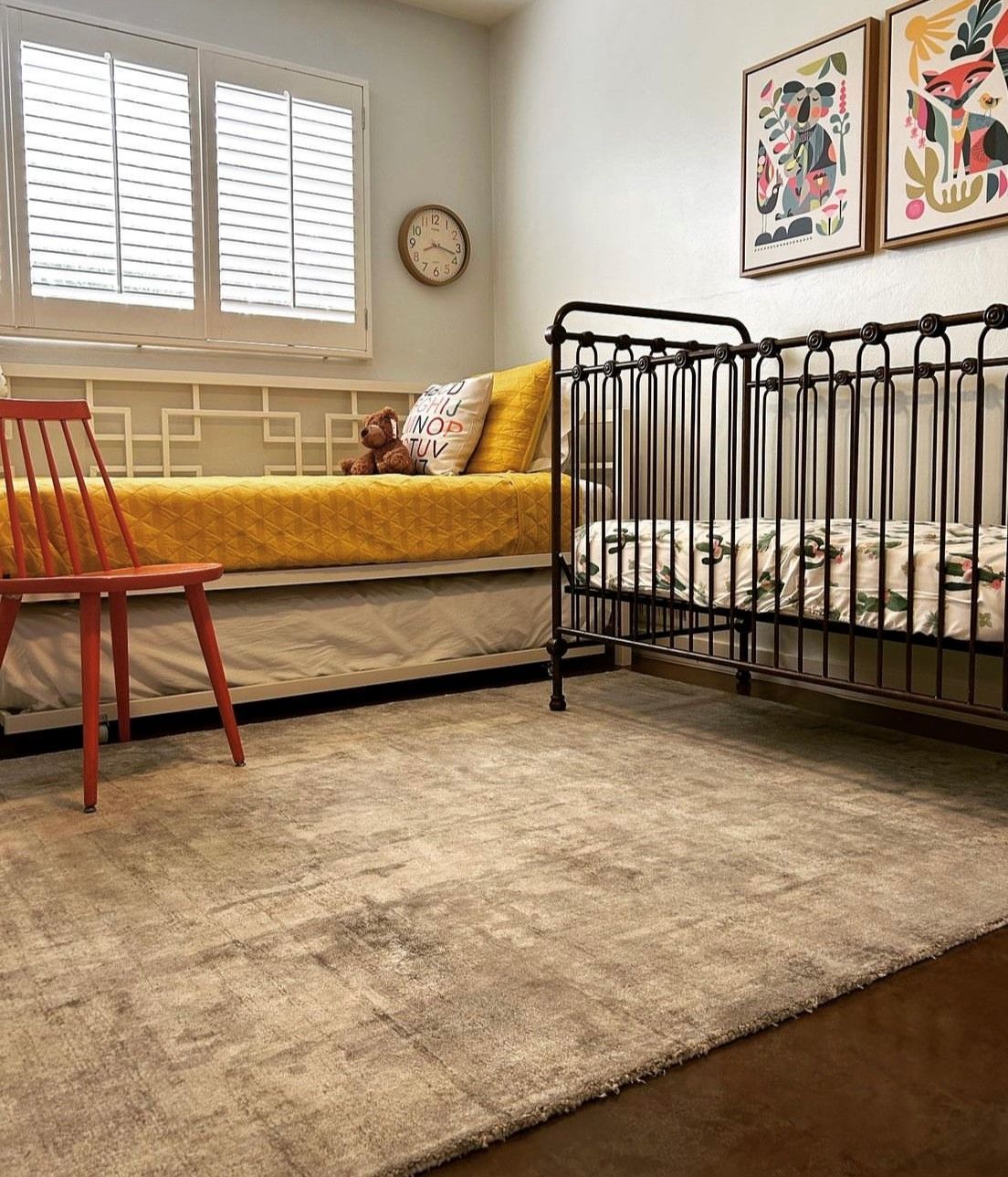 A bedroom with a crib and a day bed