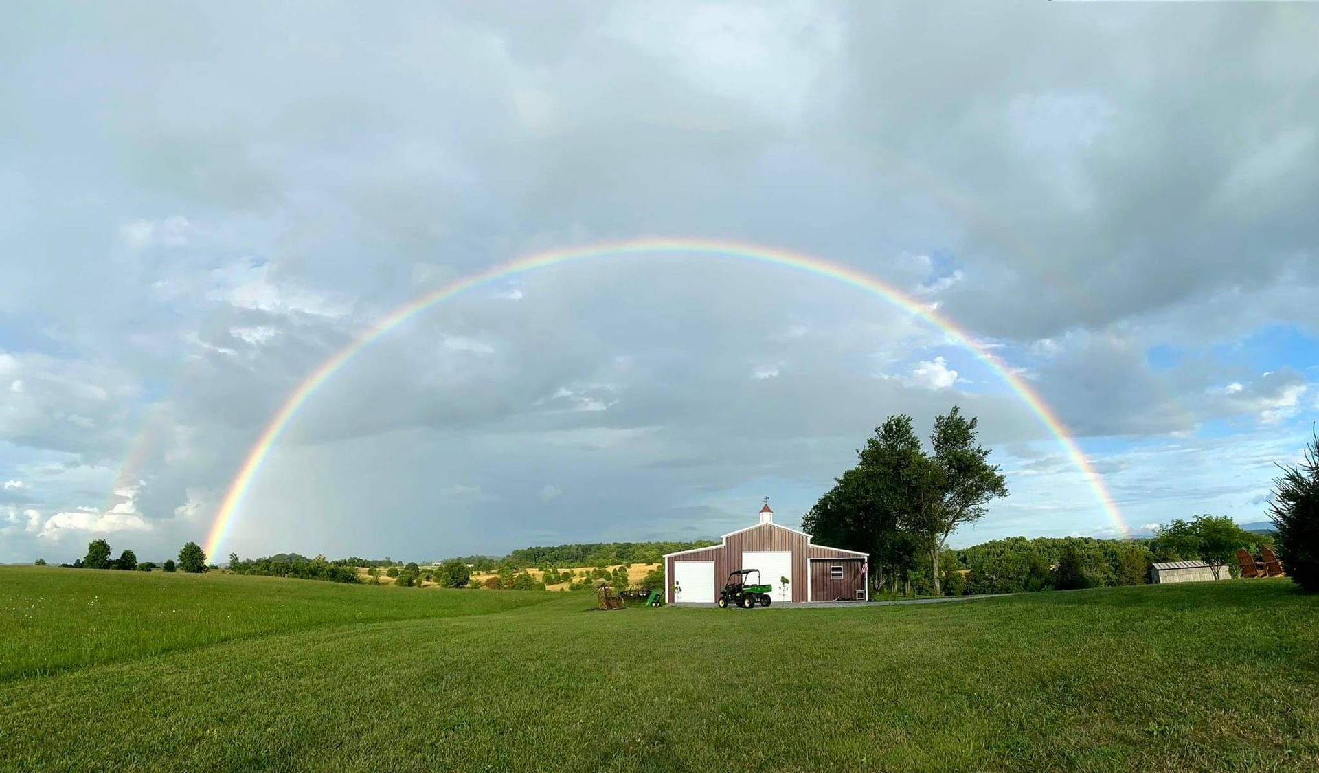 farm with a barn and rainbow