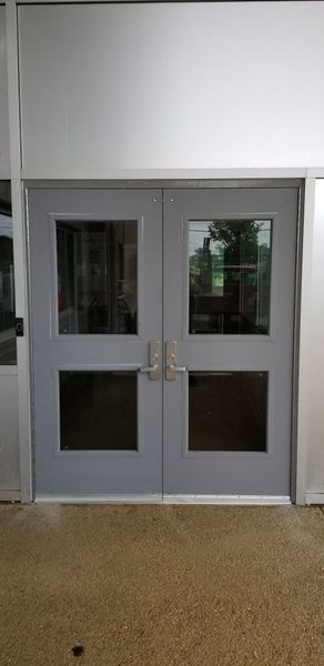 Gray double doors with glass windows.