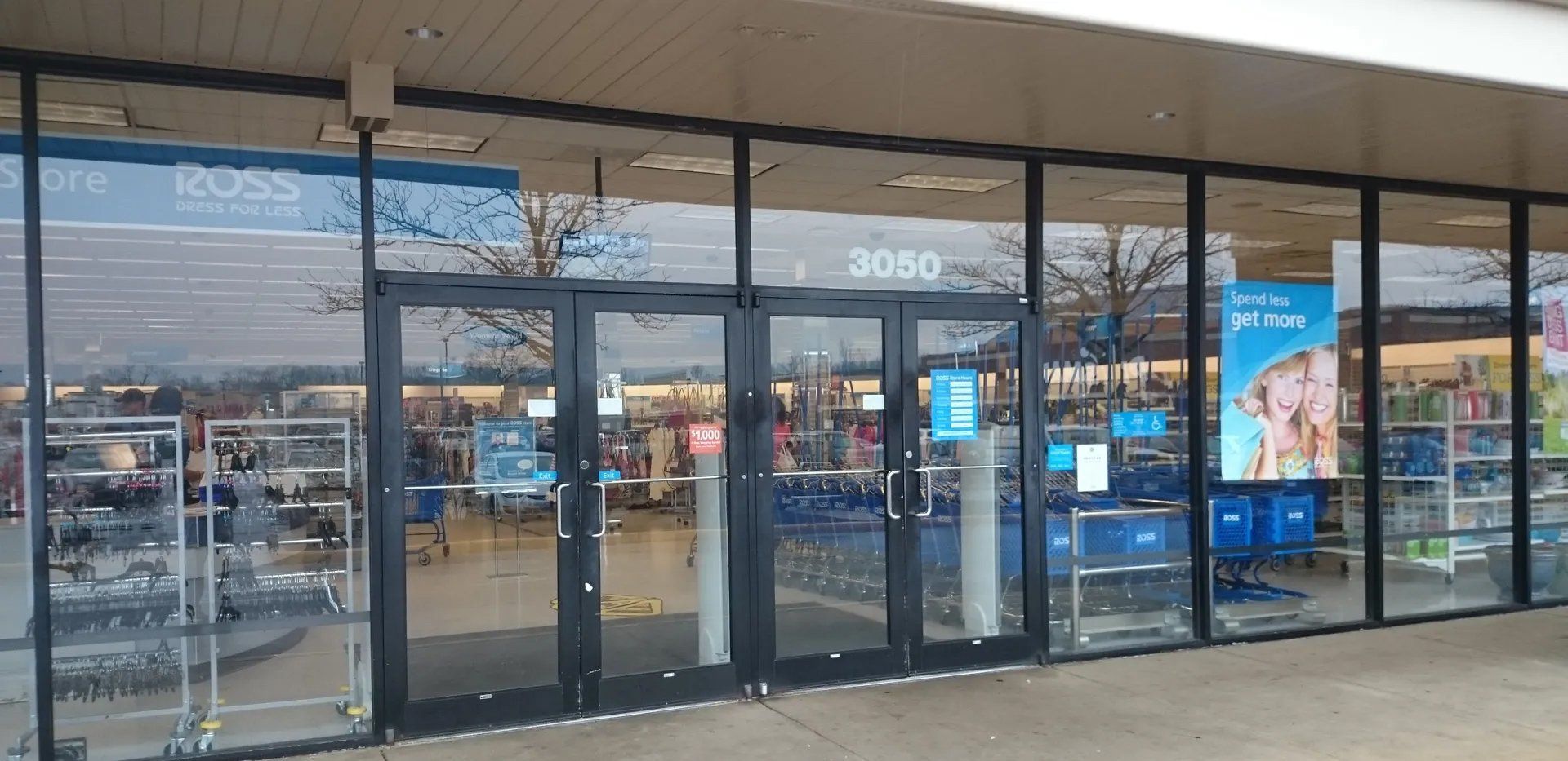 Exterior of a Ross store with glass doors and a sign above. The address 