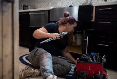 Plumber fixing the drain of a sink