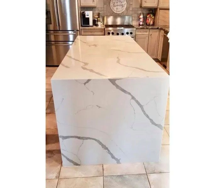 Marble-look kitchen island with white and gray veining in a modern kitchen