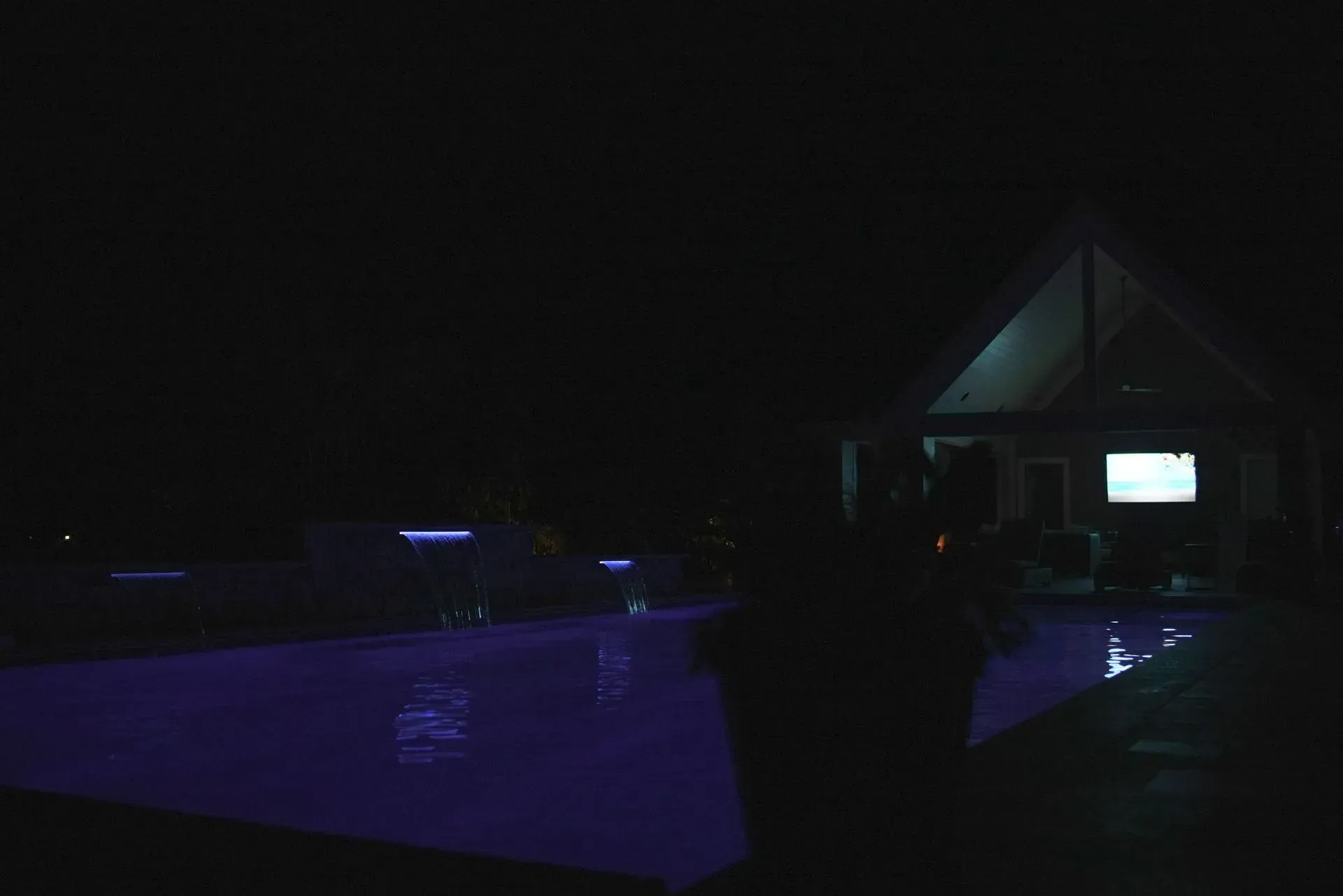 Pool illuminated in purple at night