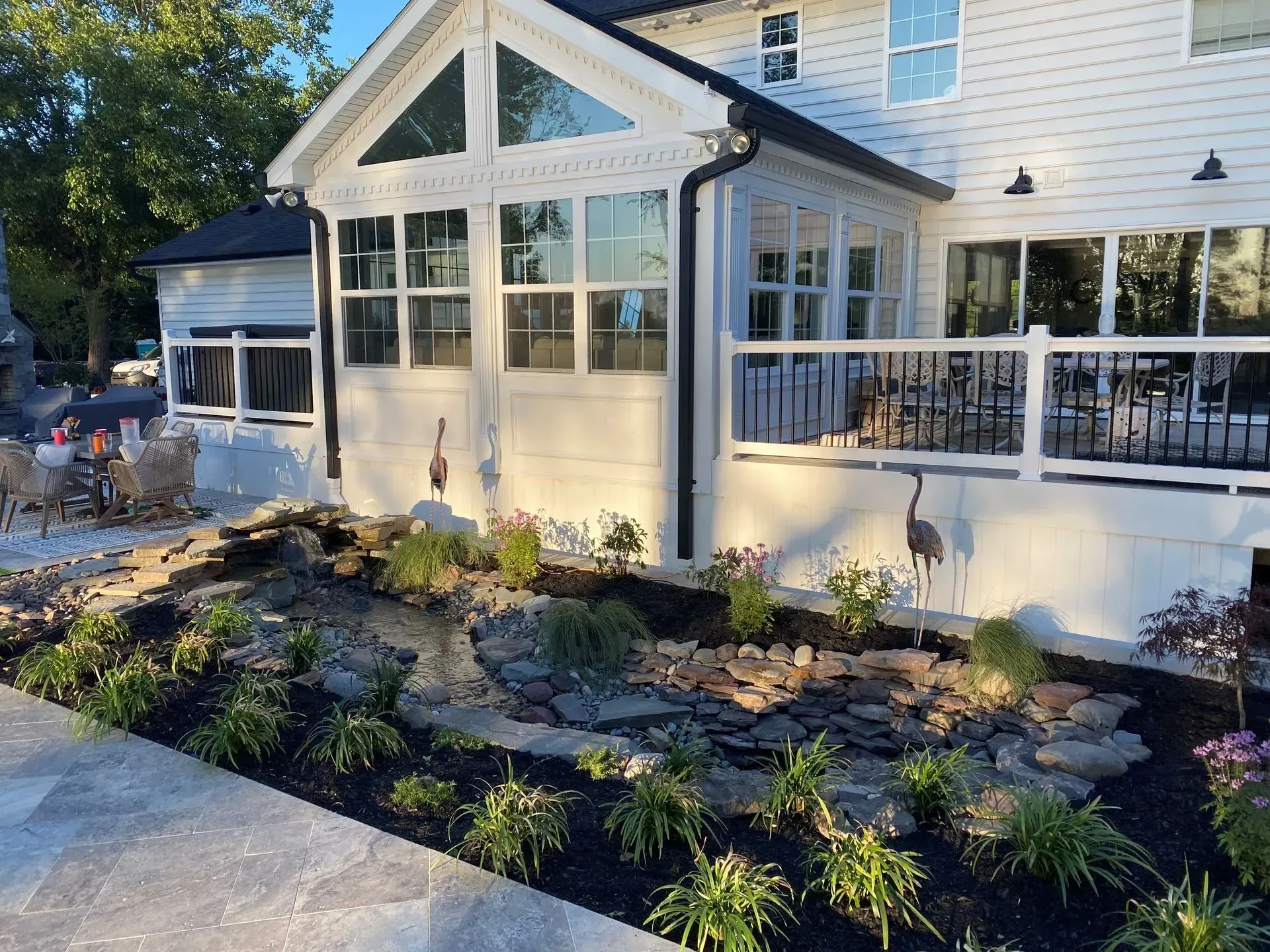 a large white house with a lot of windows and a patio