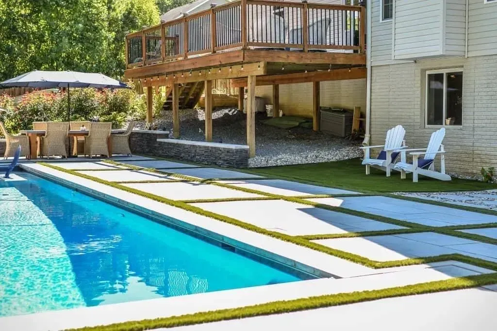 there is a large swimming pool in the backyard of a house