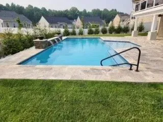 there is a large swimming pool in the backyard of a house