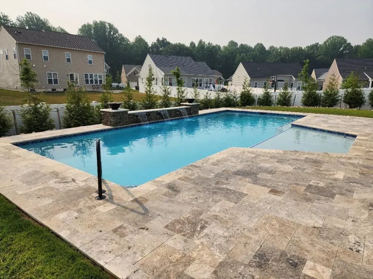 there is a large swimming pool in the backyard of a house