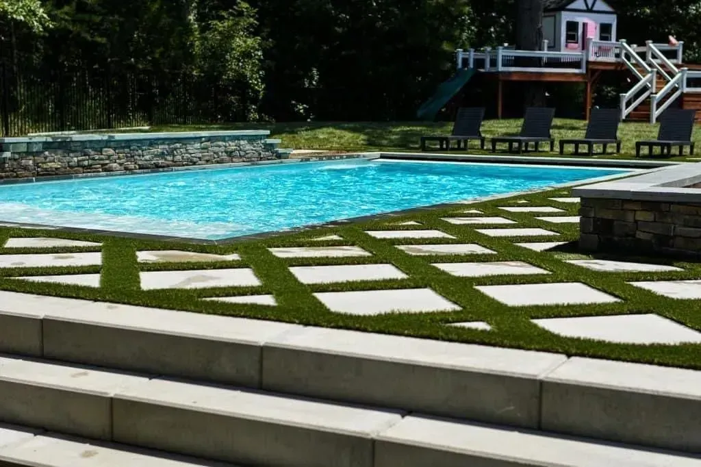 a large swimming pool with a playhouse in the background