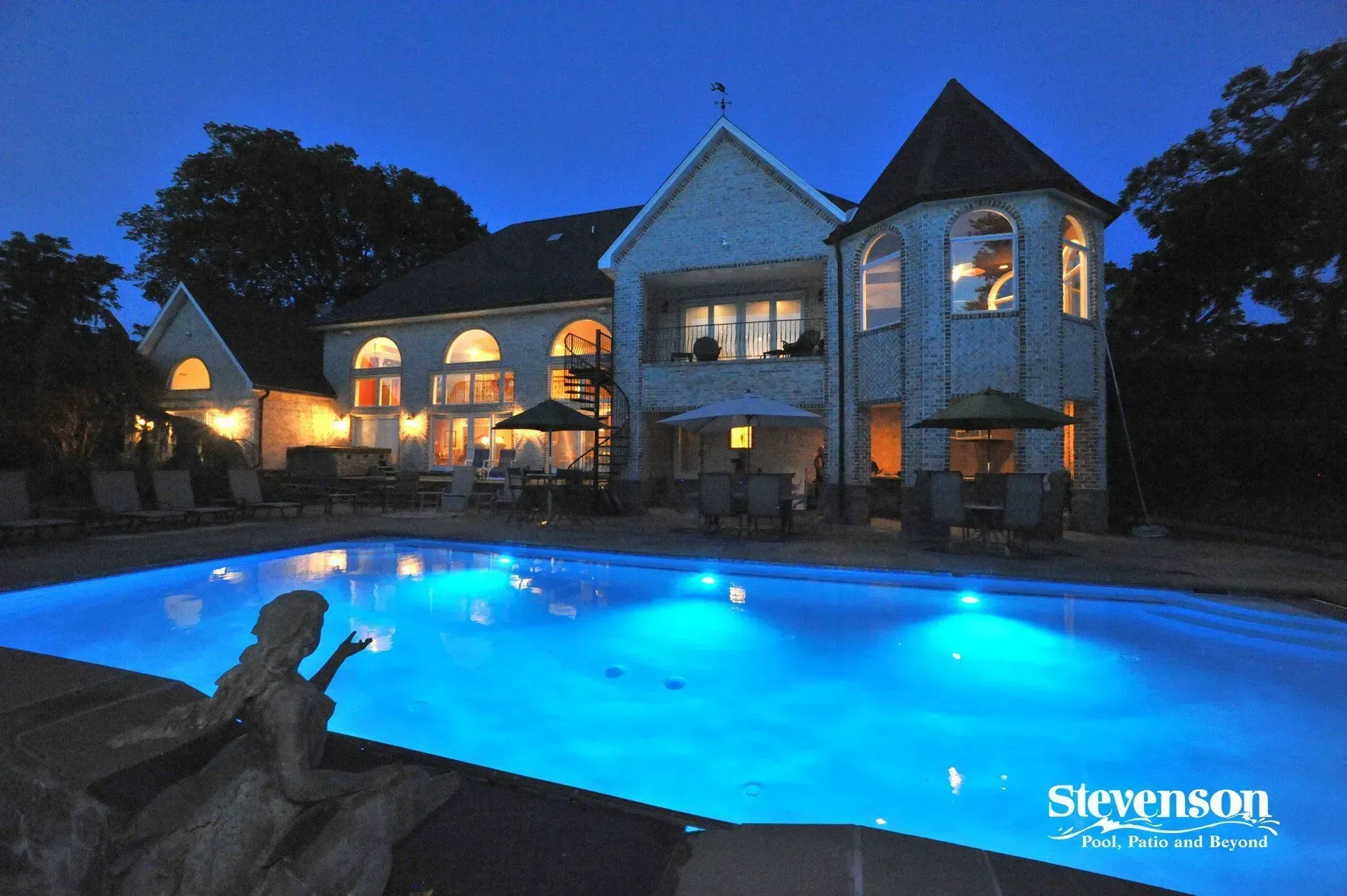 a large house with a large swimming pool in front of it