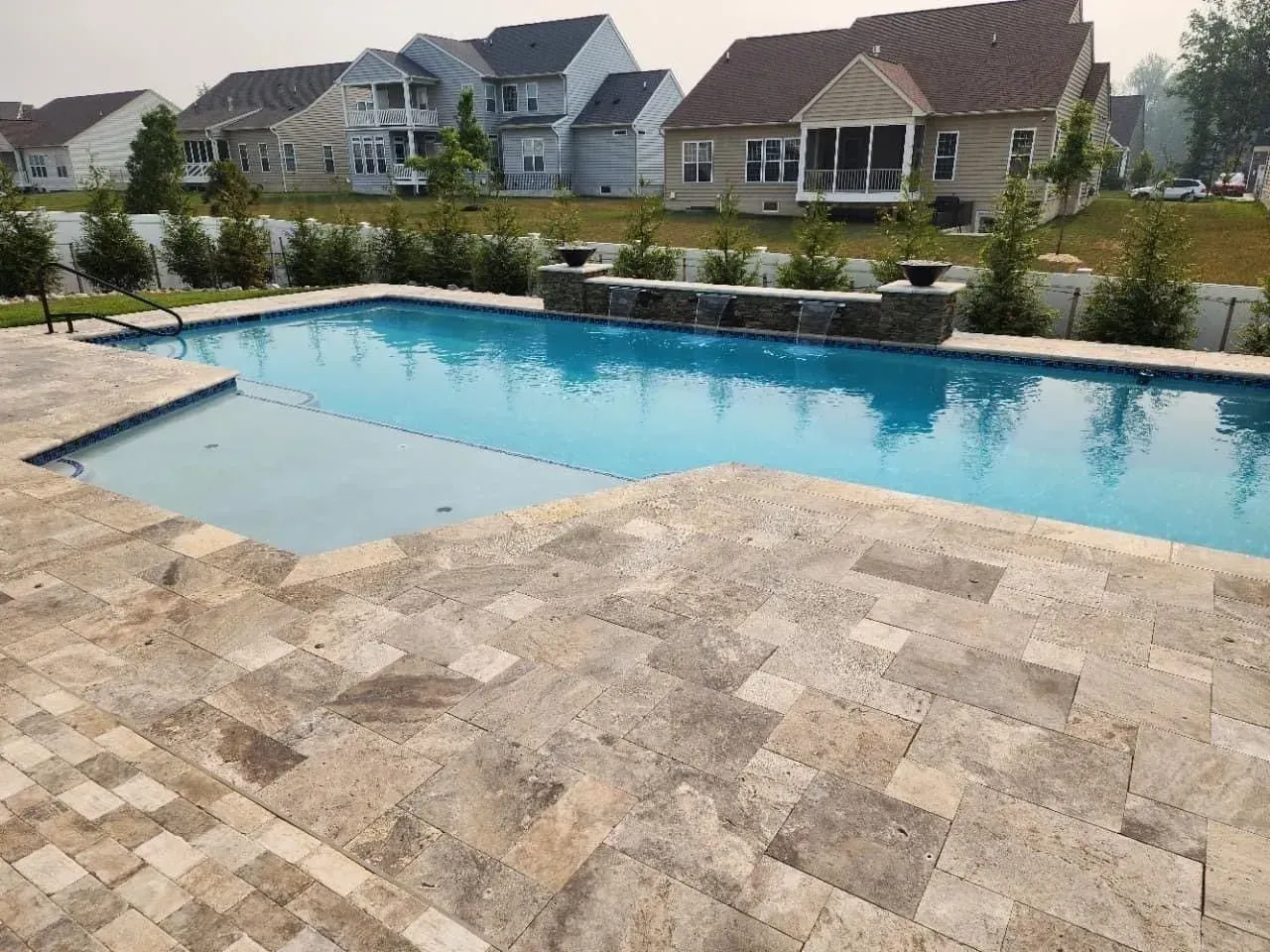 there is a large swimming pool in the backyard of a house
