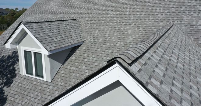 Gray shingle roof with two dormer windows on a house