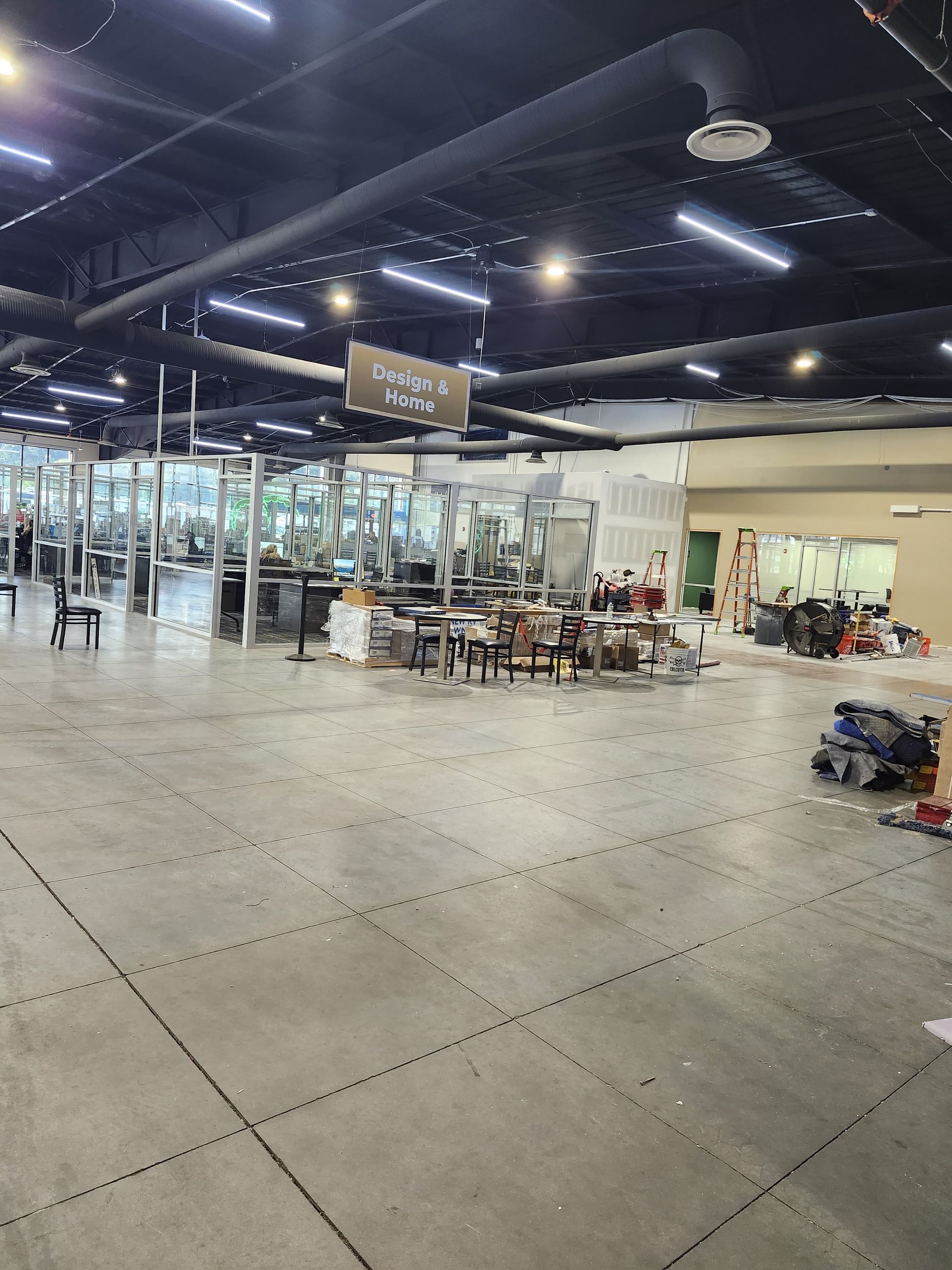 Spacious airport terminal with seating, glass walls, and travelers near a check-in area