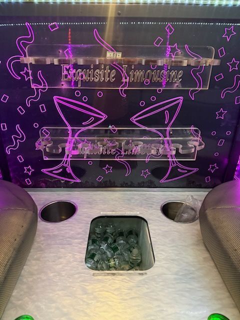 Cocktail station: black backdrop with purple neon, glass holders, bottles, and 