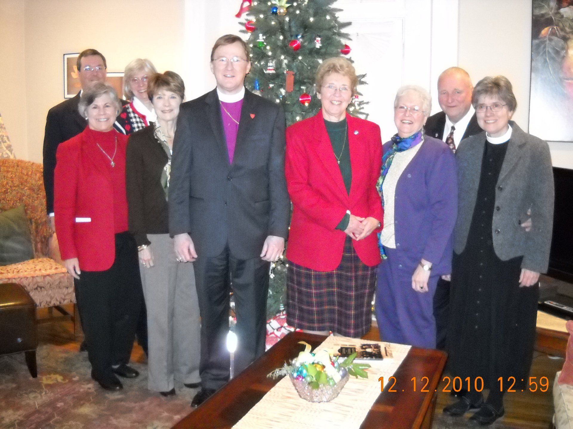 People standing in front of a Christmas tree