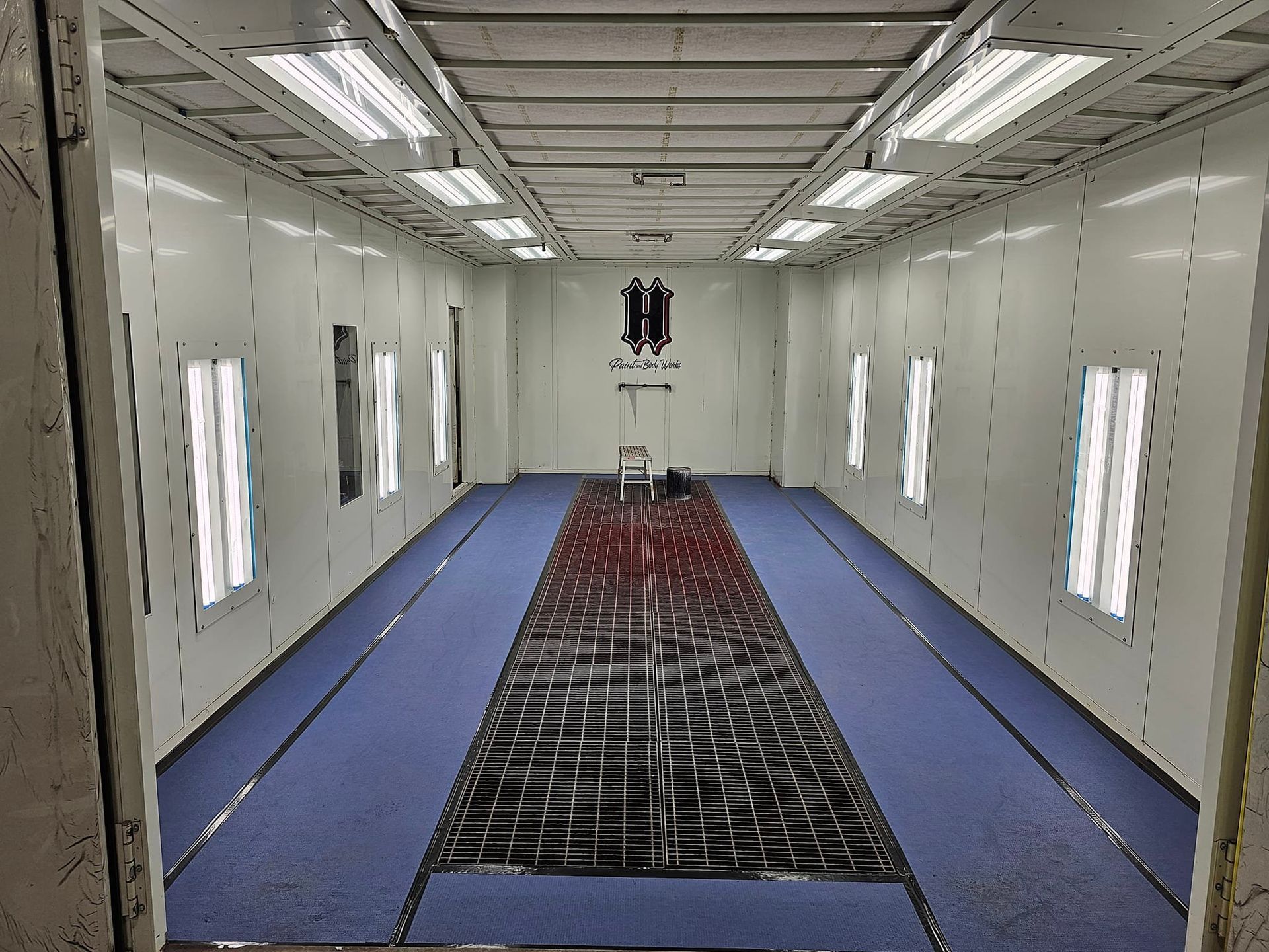 A large room with a lot of windows and a blue floor