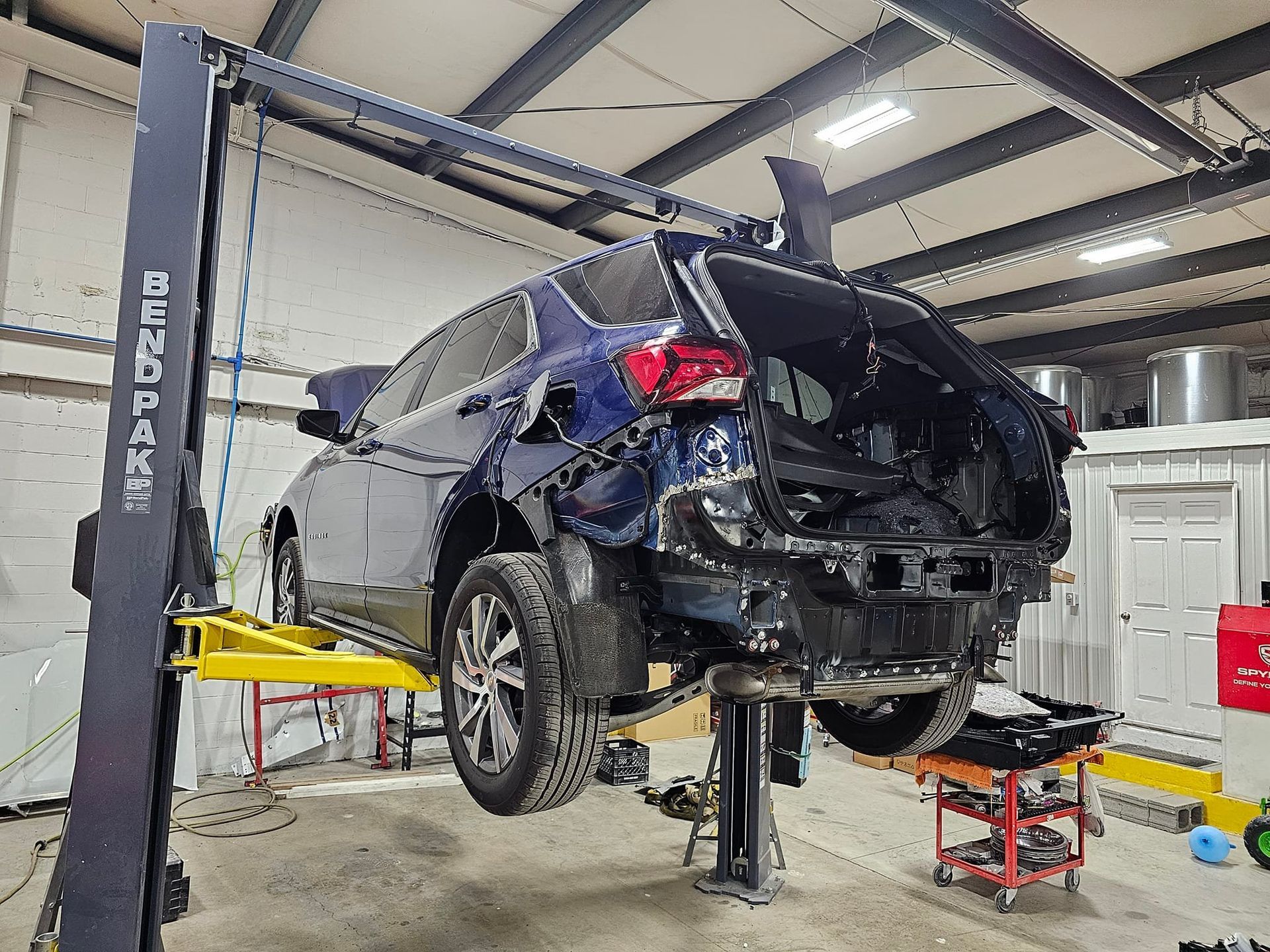 A car is sitting on a lift in a garage
