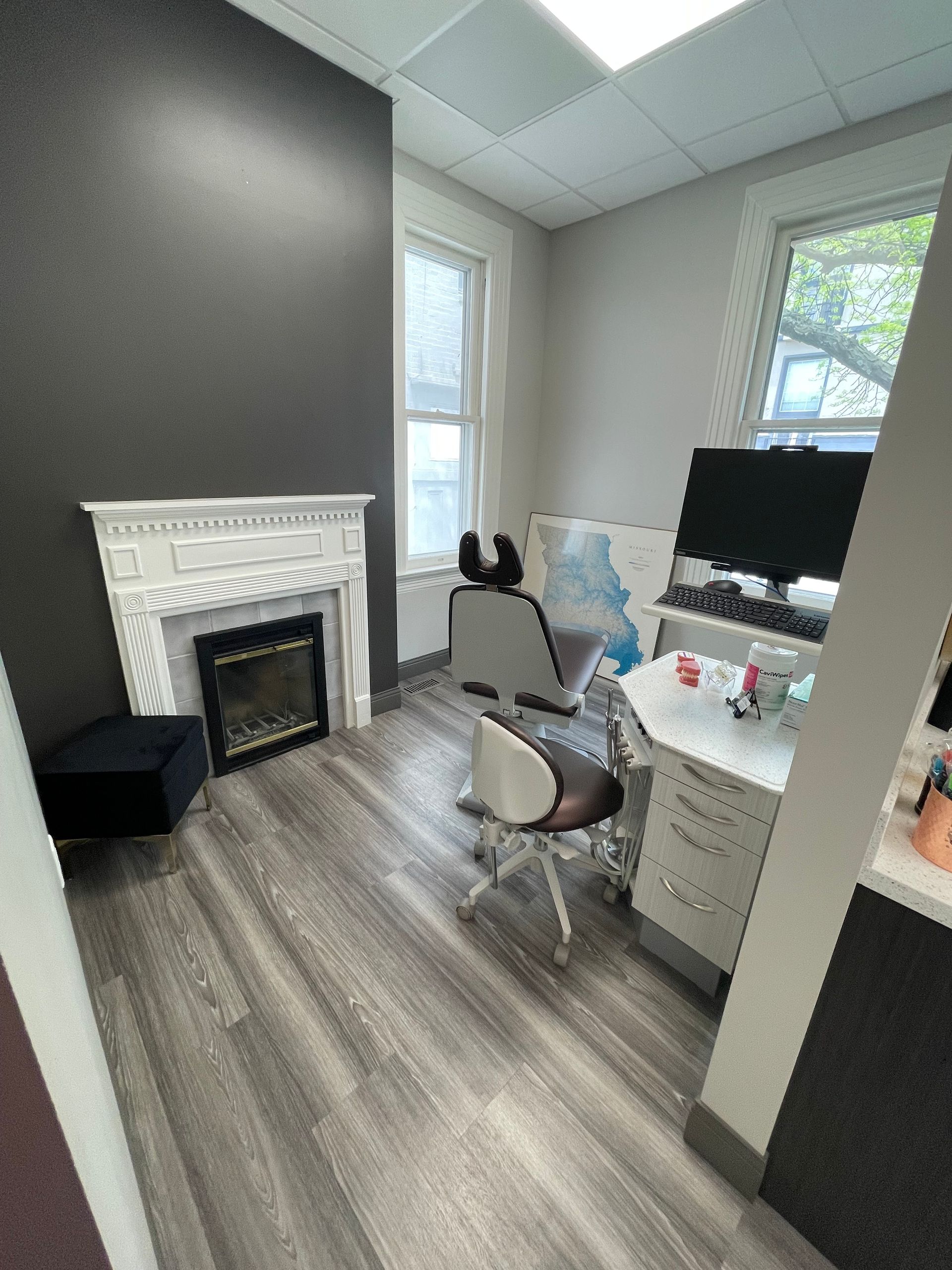 Junction Orthodontics office with computer, chair, and a fireplace