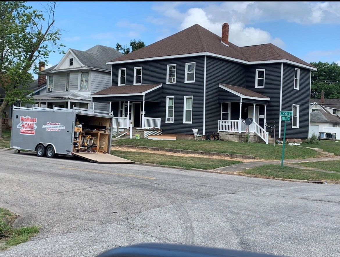 Dark gray house with brown roof