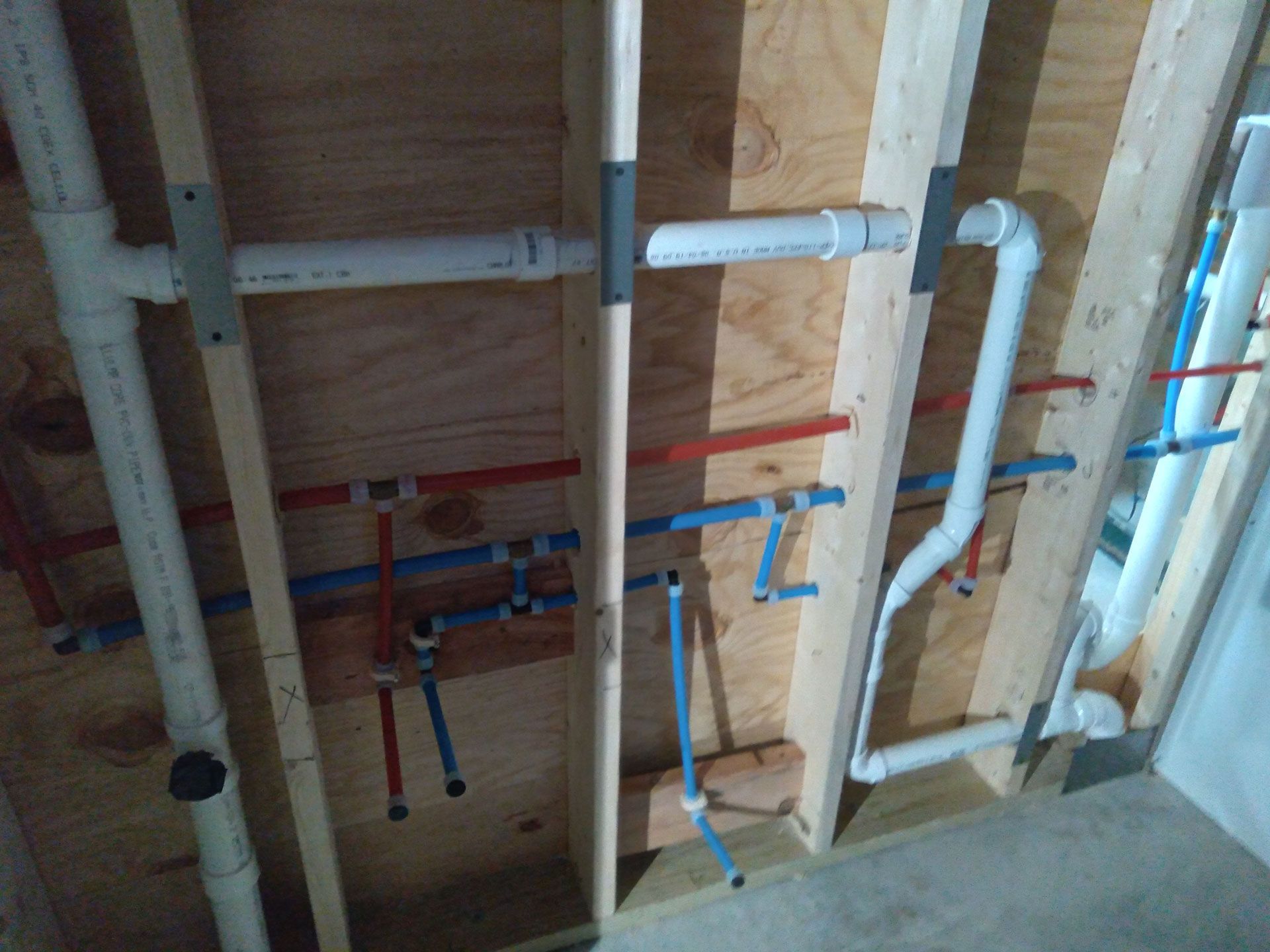 A room with a lot of pipes hanging from the ceiling