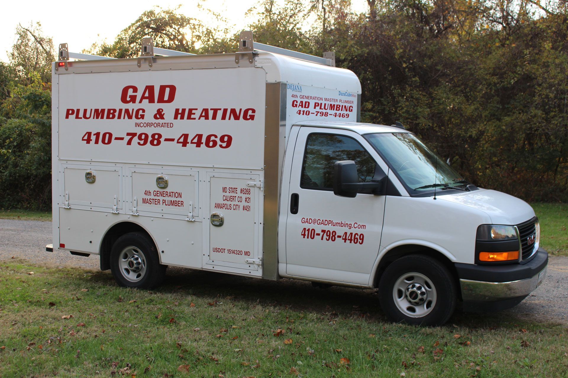 A white van that says gad plumbing and heating