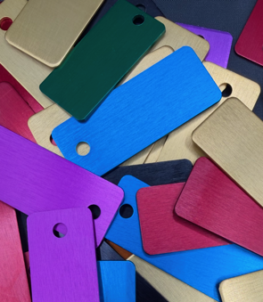 Stacked colorful pieces with holes in blue, purple, pink, green, and beige.