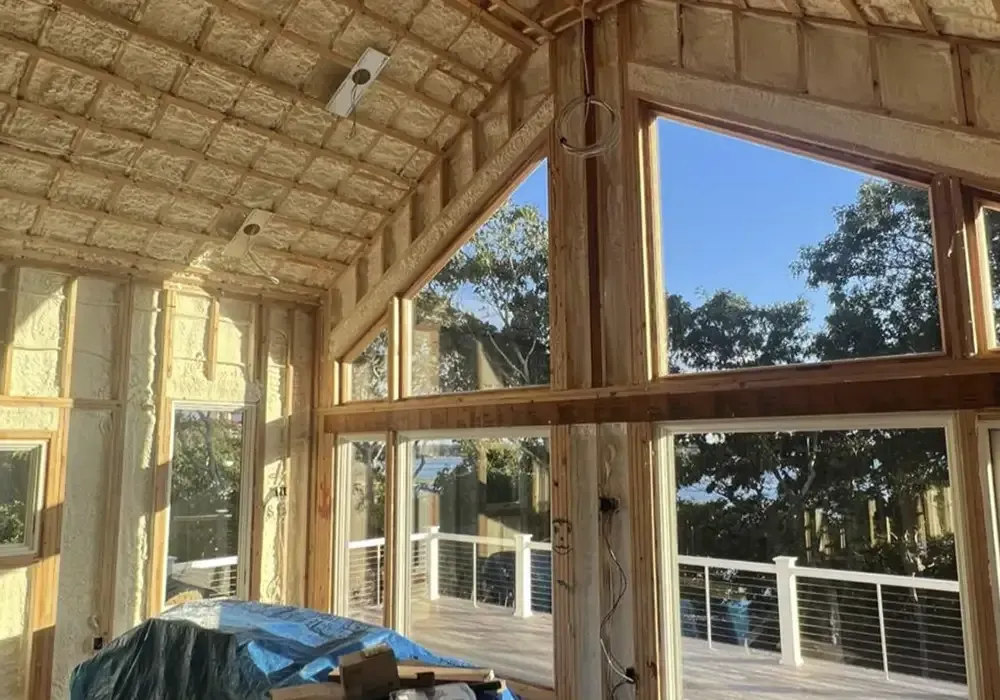 A house is being built with a lot of windows and insulation.