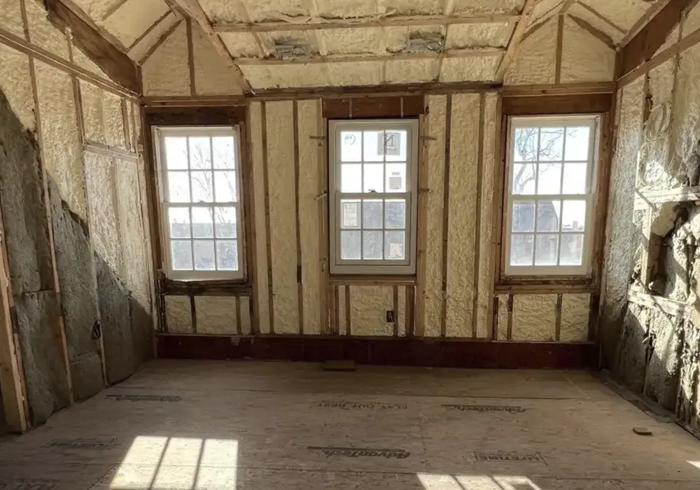 An empty room with a lot of insulation and windows.