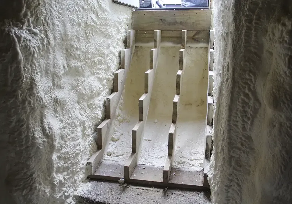 A staircase in a cave covered in foam.