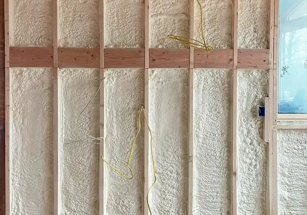 A wall with a lot of foam on it and a window.