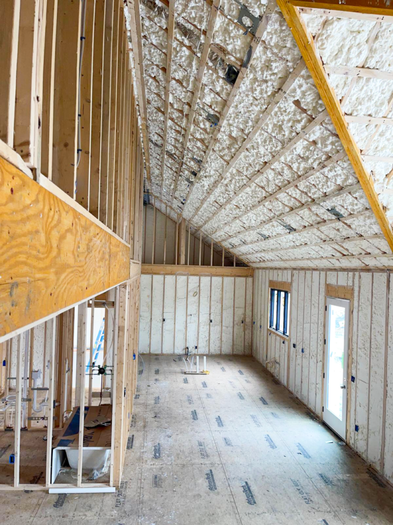 The inside of a house under construction with foam on the ceiling.