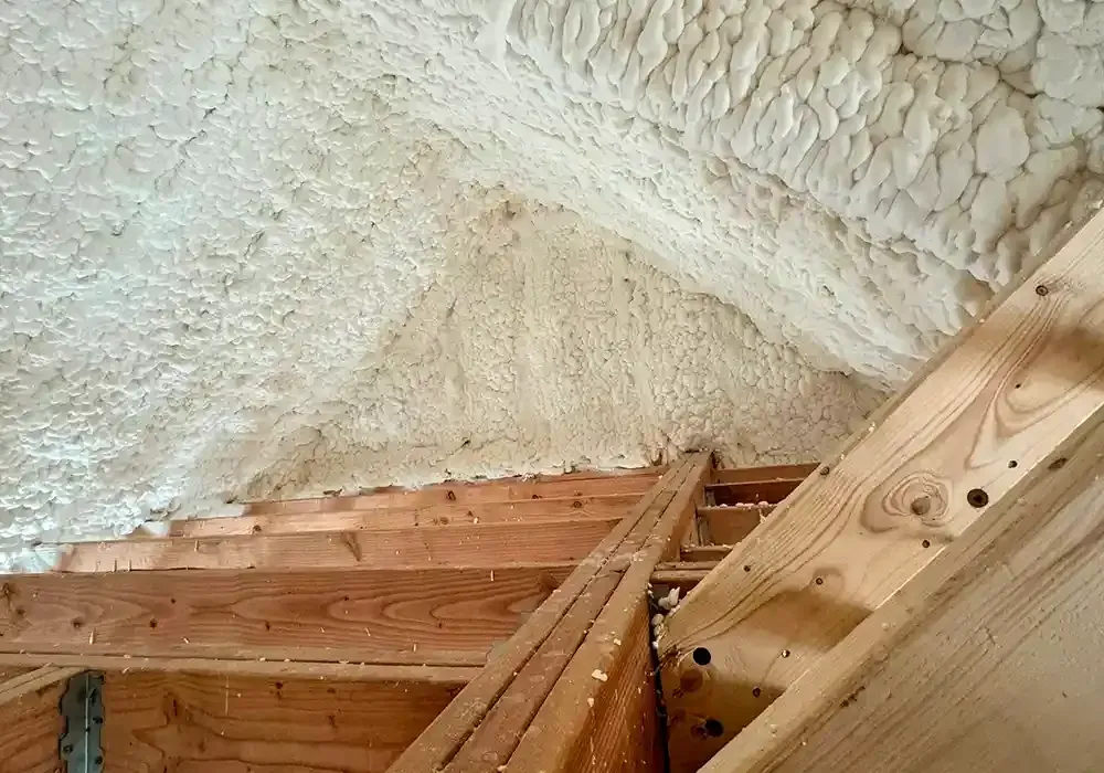 The ceiling of a house is covered in spray foam.