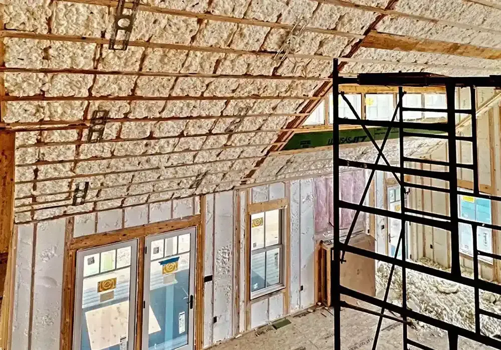 A house is being built with a lot of insulation on the walls and ceiling.