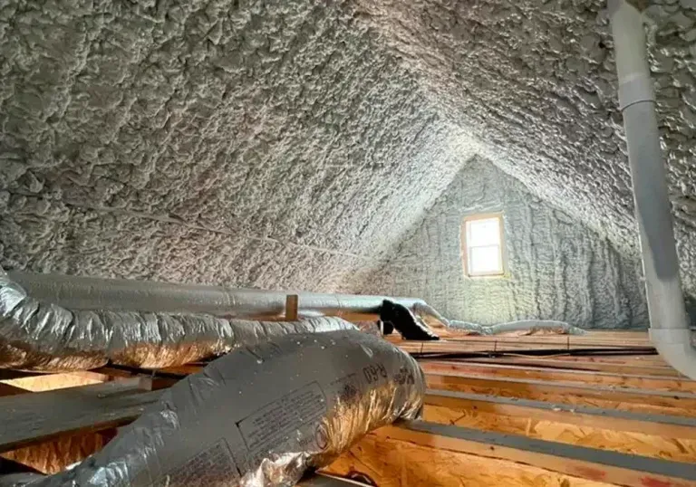 The attic of a house is insulated with spray foam.