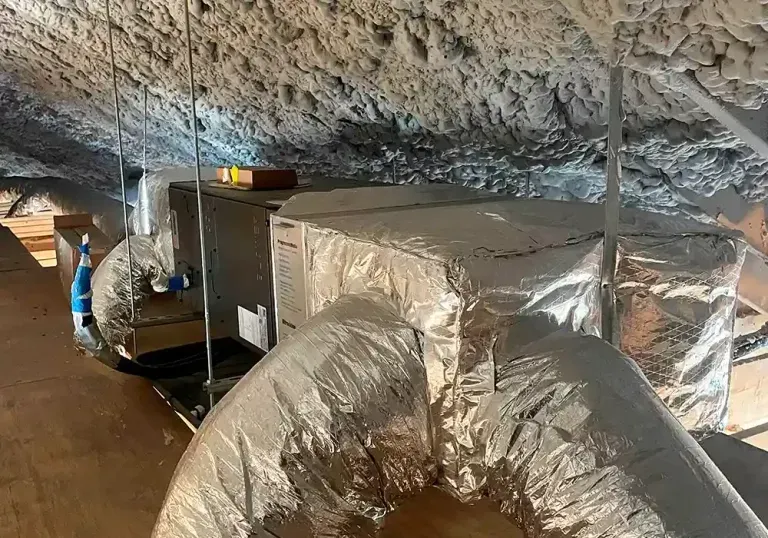 There is a duct in the attic that is covered in aluminum foil.