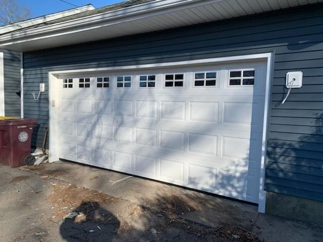 White garage door with small square windows above