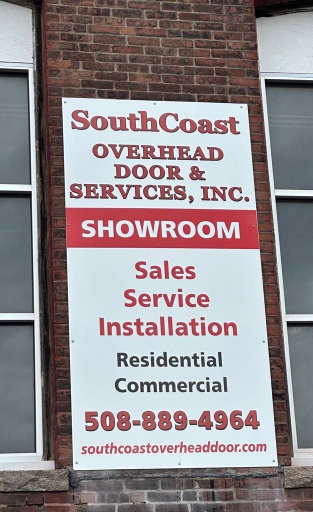 Sign for SouthCoast Overhead Door & Services with showroom info, services, and phone number