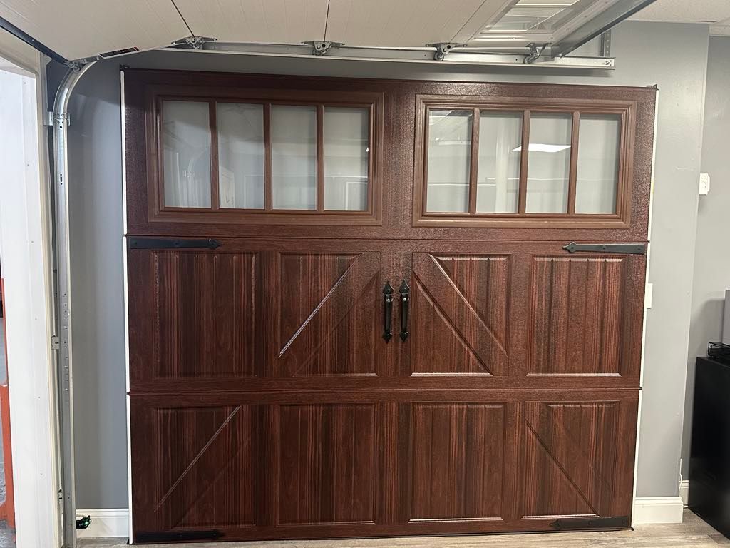 Dark brown garage door with glass windows