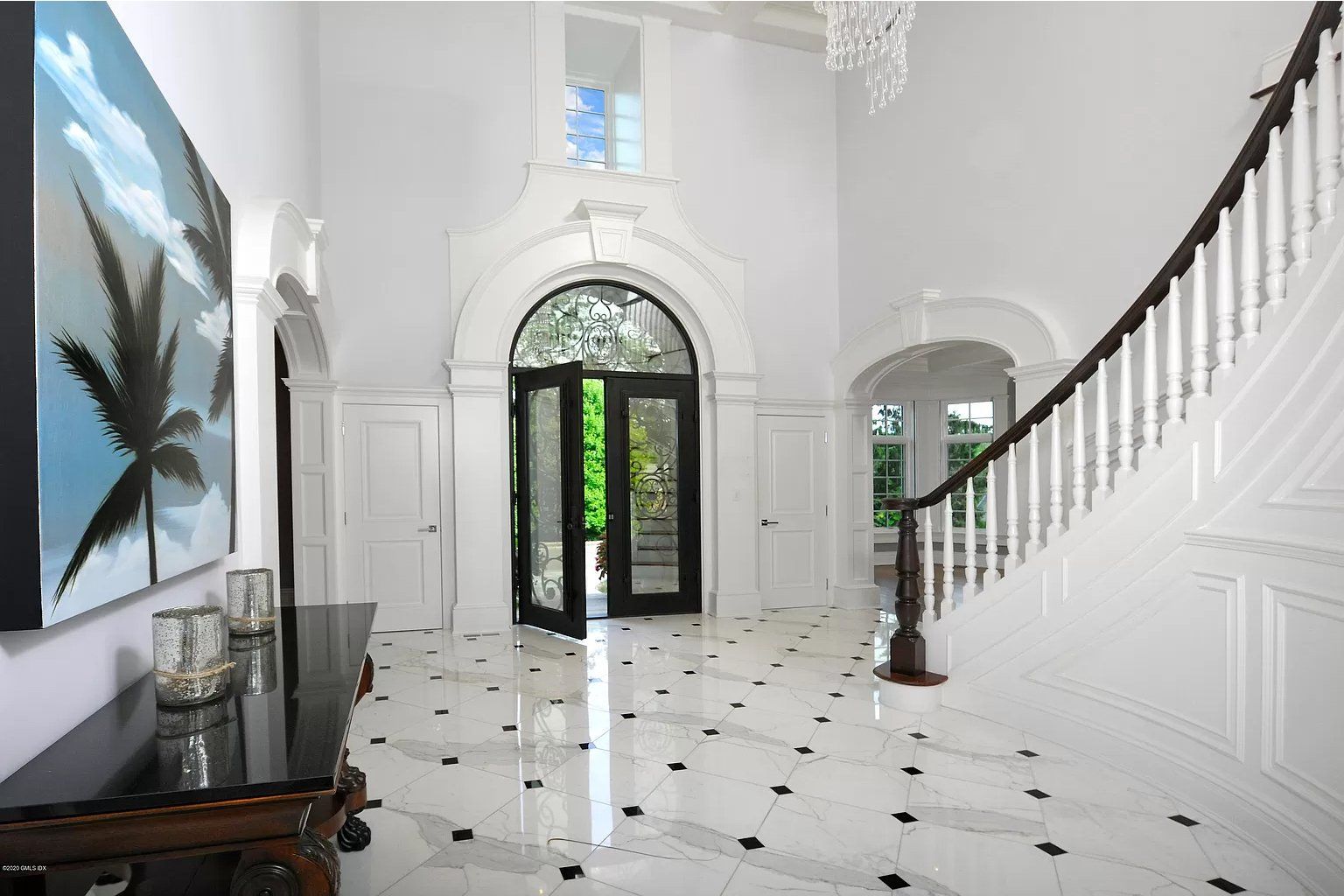 Black metal front door and foyer with spiral staircase