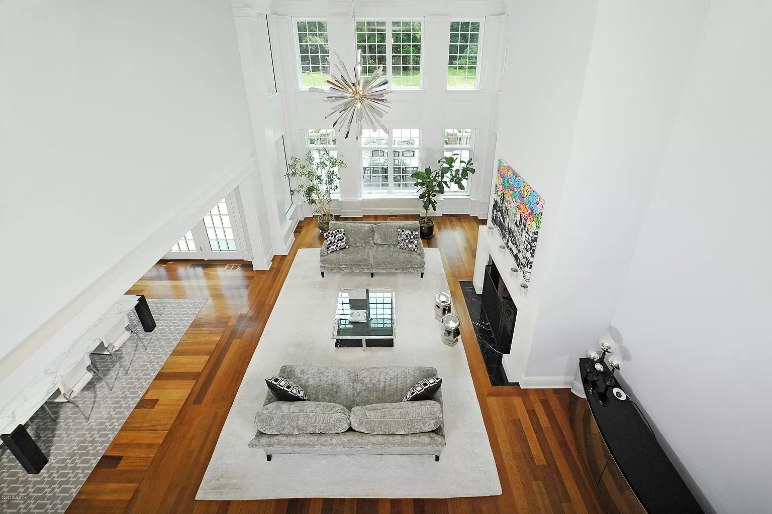 Living room with white walls and high ceiling