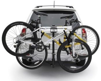 Two bicycles are attached to the back of a car.
