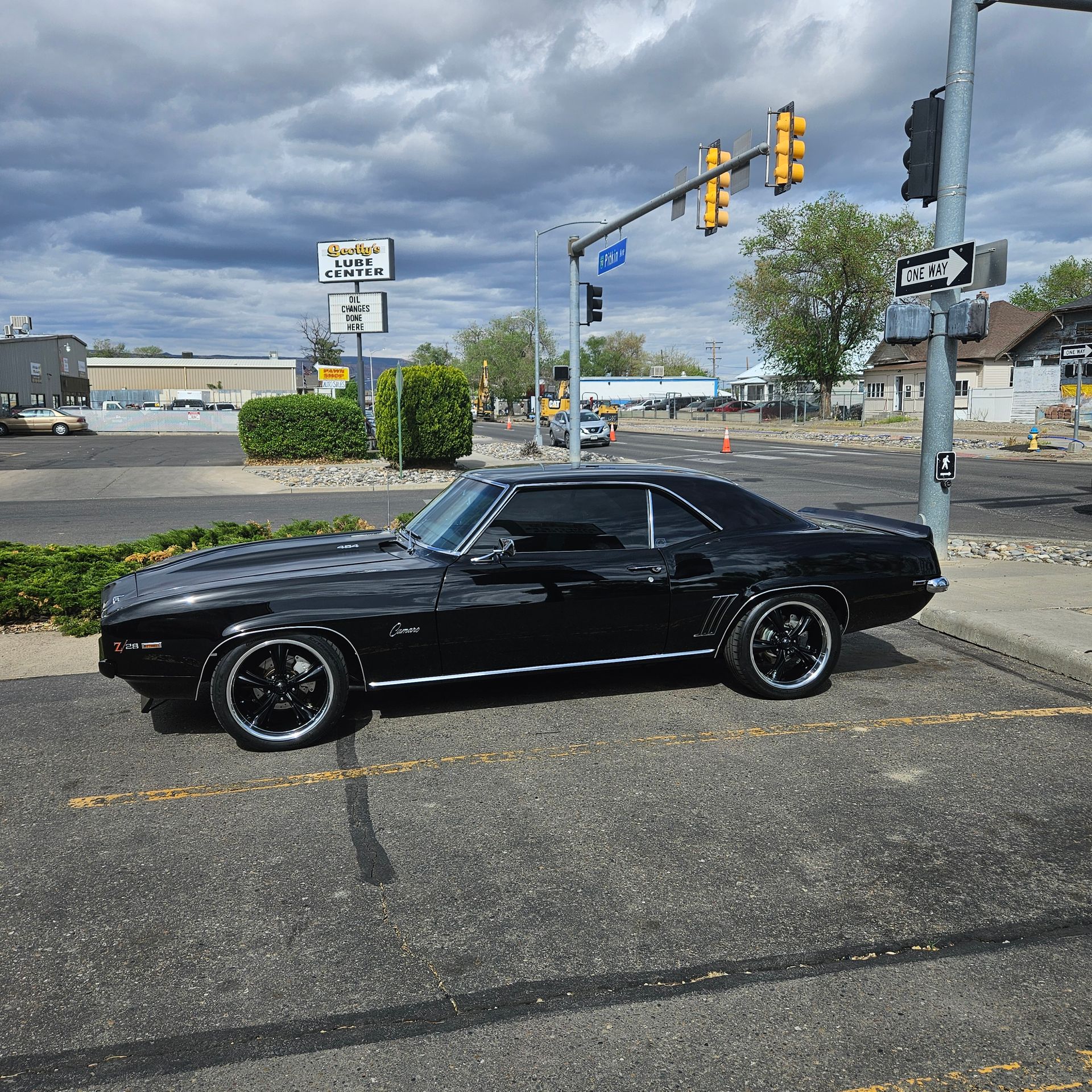 A black car is parked on the side of the road